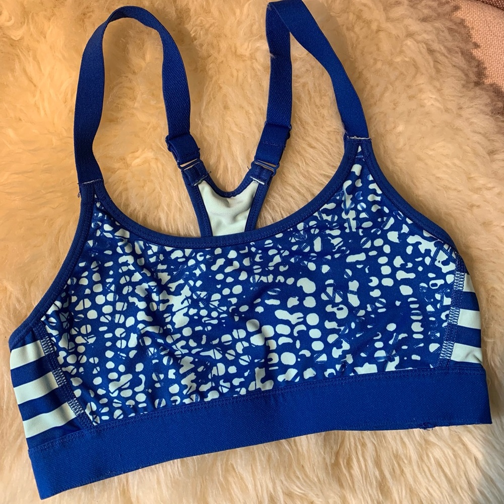 Blue polka-dot and striped sports bra with adjustable straps.